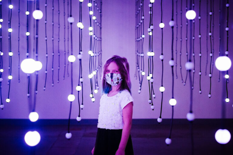 girl standing in blinking art installation at wonderspaces in austin texas