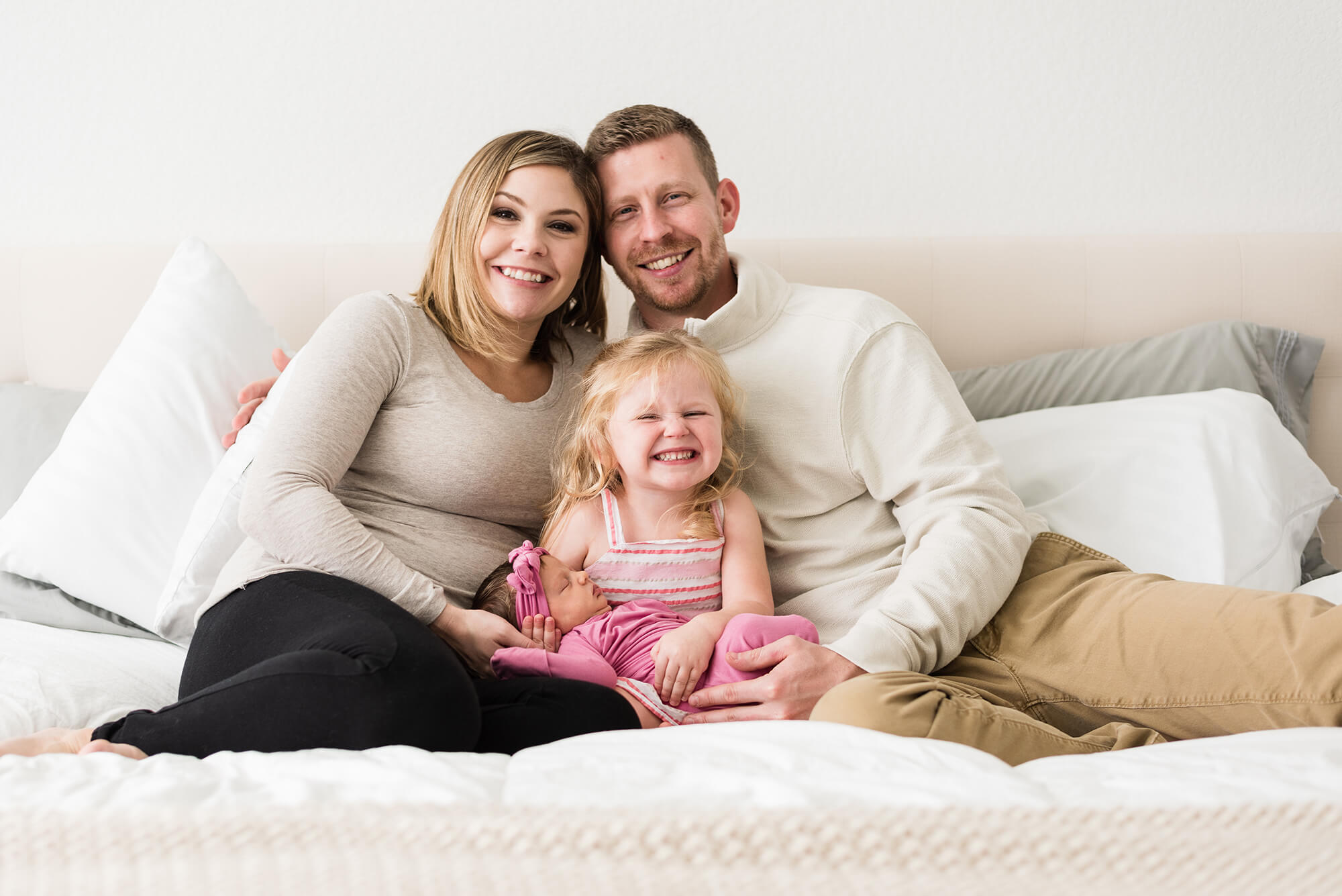 family cuddling together on bed during family film session in buda texas