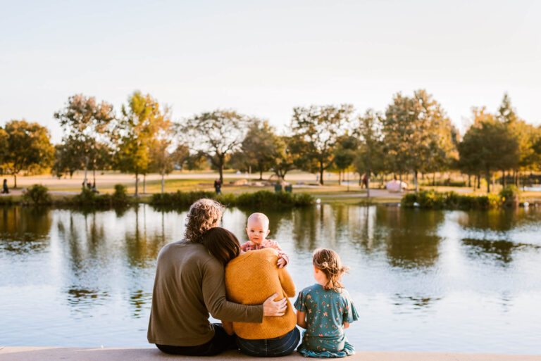 family looking out at the lake at mueller during family portraits