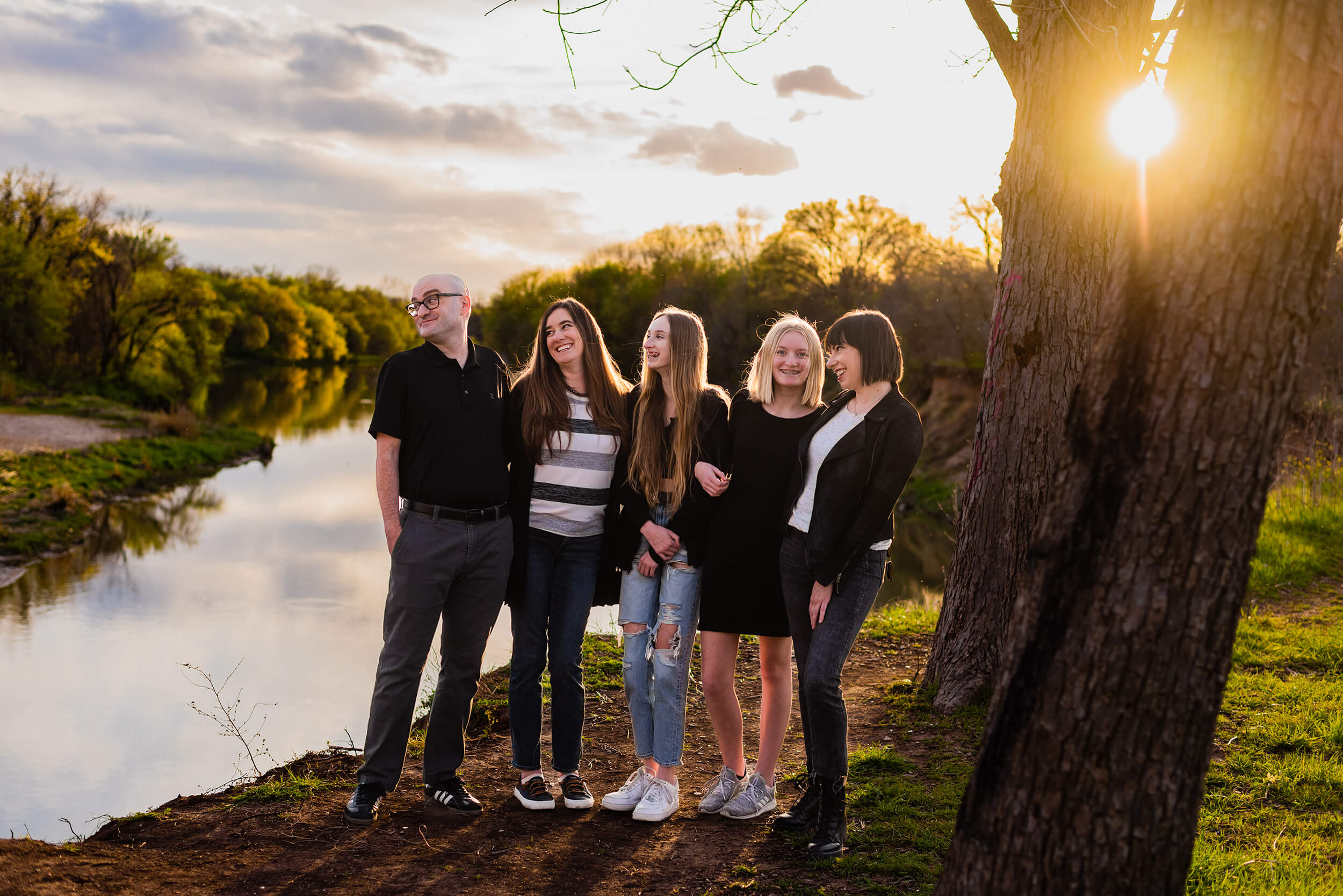 family posing for family photo session at the colorado river in austin texas