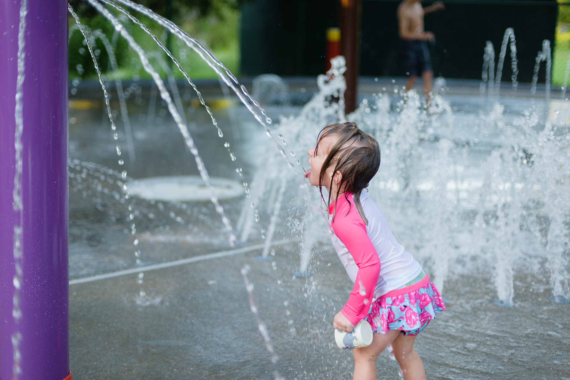 girl playing at a splashpad in austin texas