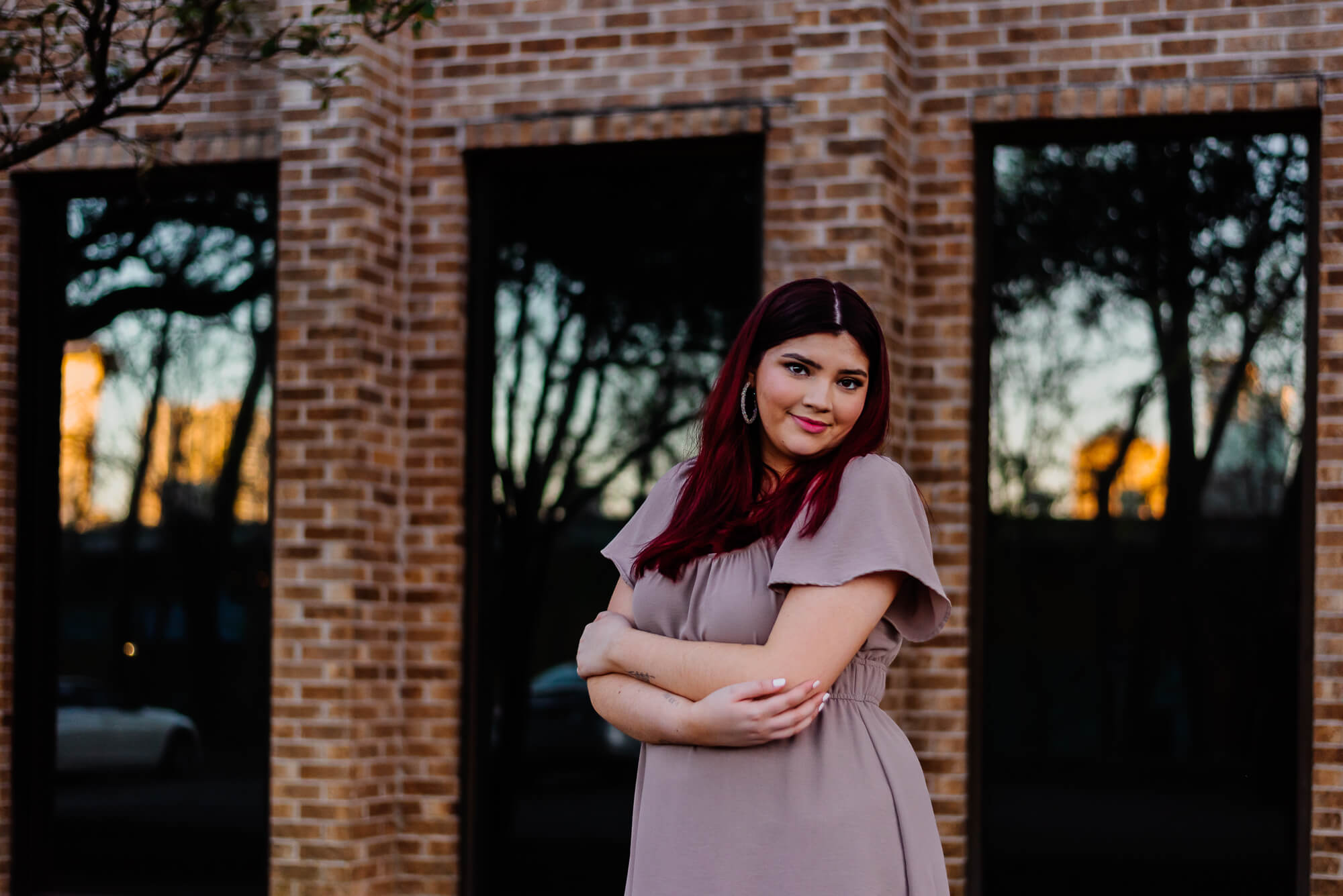 girl hugging herself for her senior photos on south congress avenue in austin texas