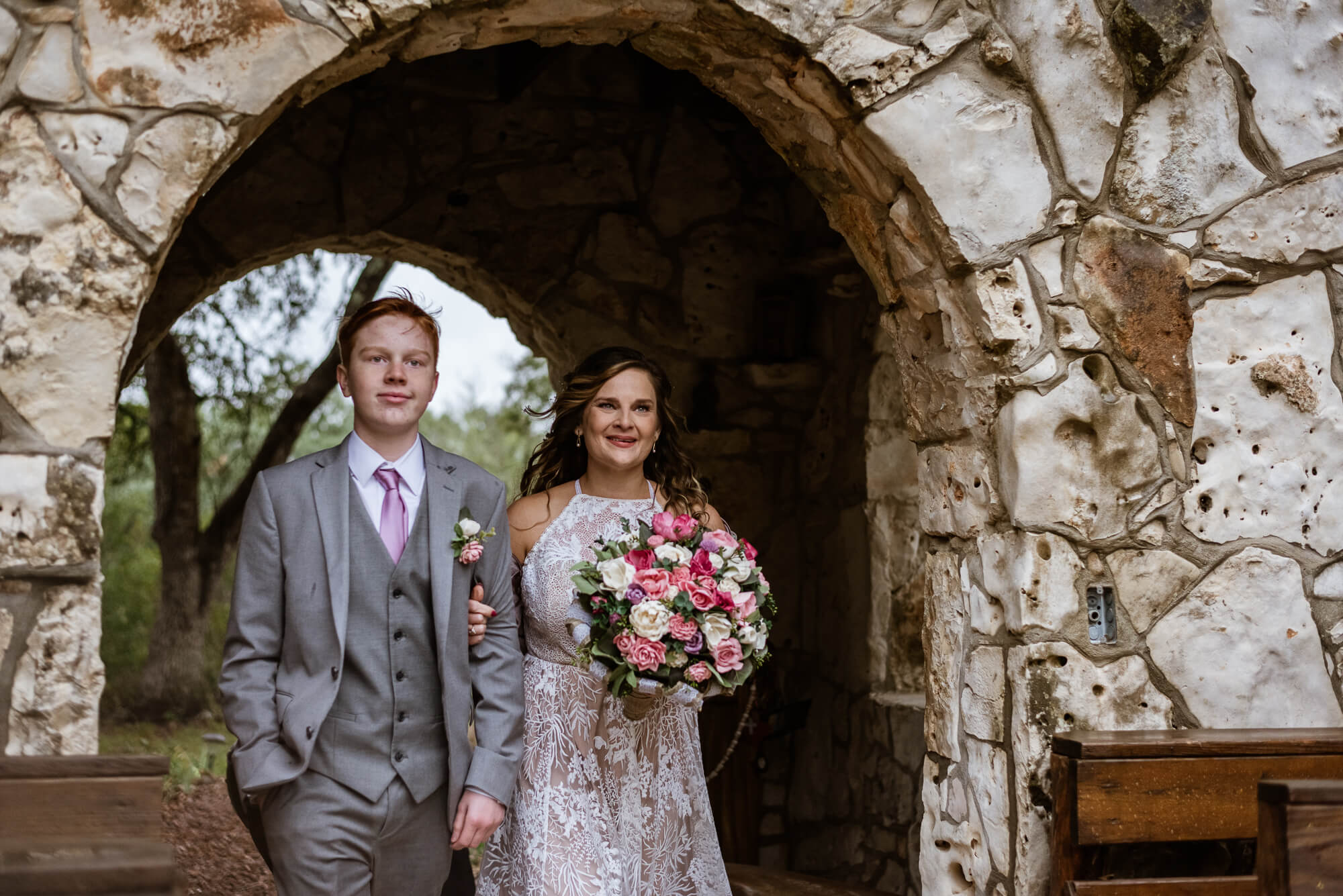 the bride walking down the isle at sacred passages chapel