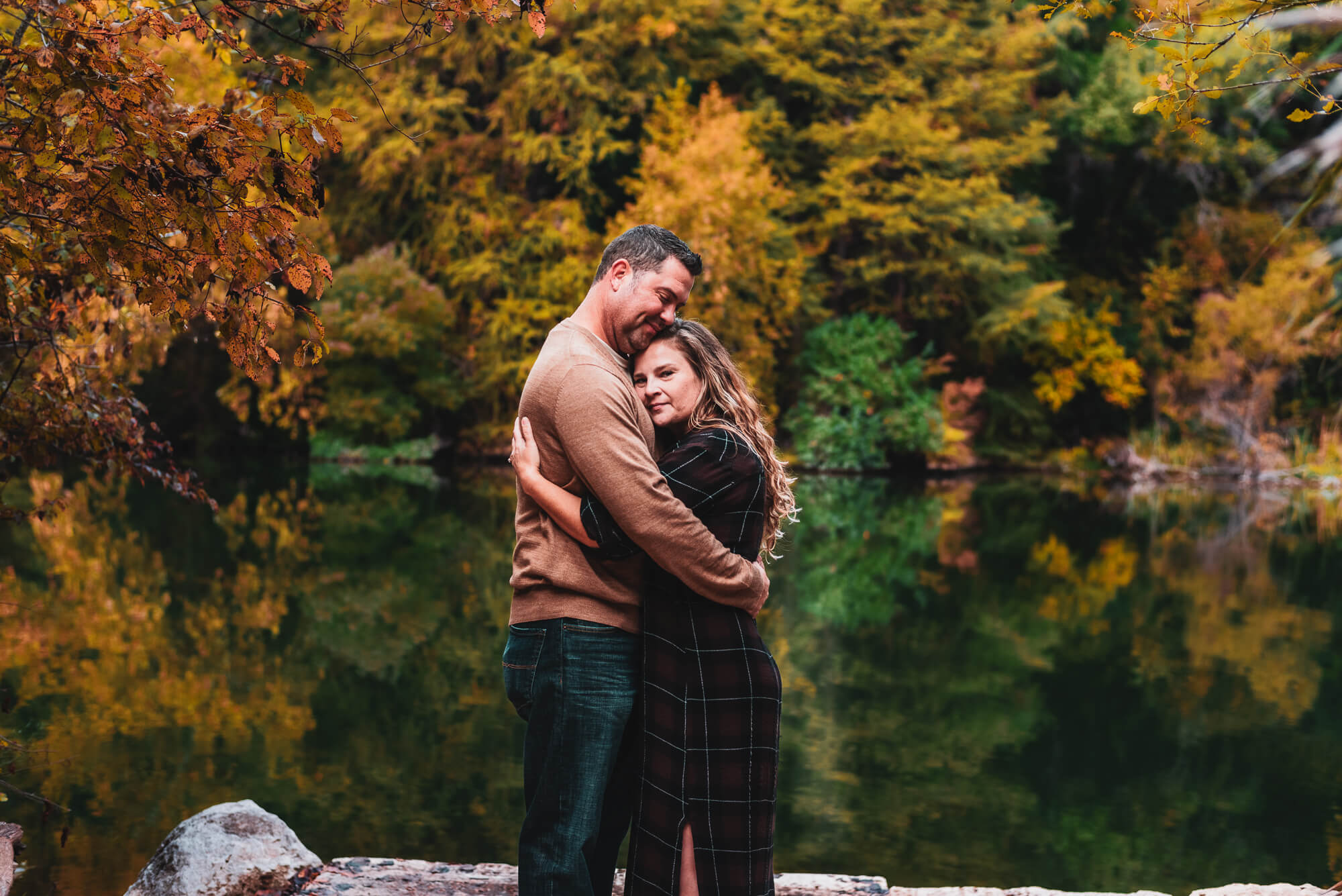 couple hugging during their engagement photoshoot at red bud isle in austin