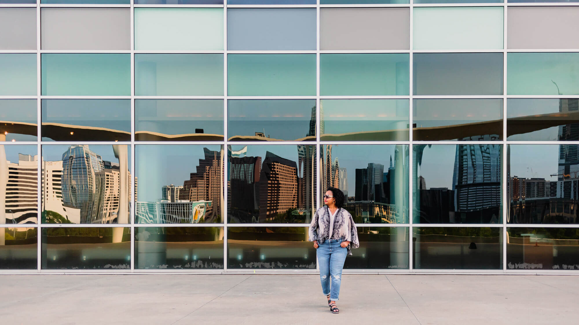 woman entrepreneur walking doing a brand photoshoot at the long center in austin texas