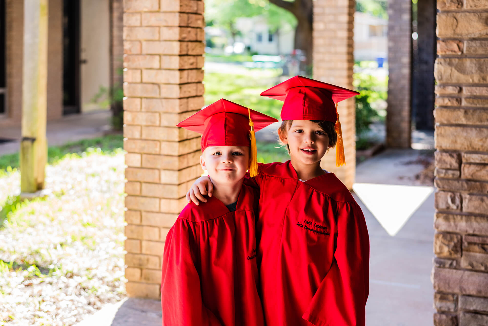 pre-k kids wearing graduation cap and gown