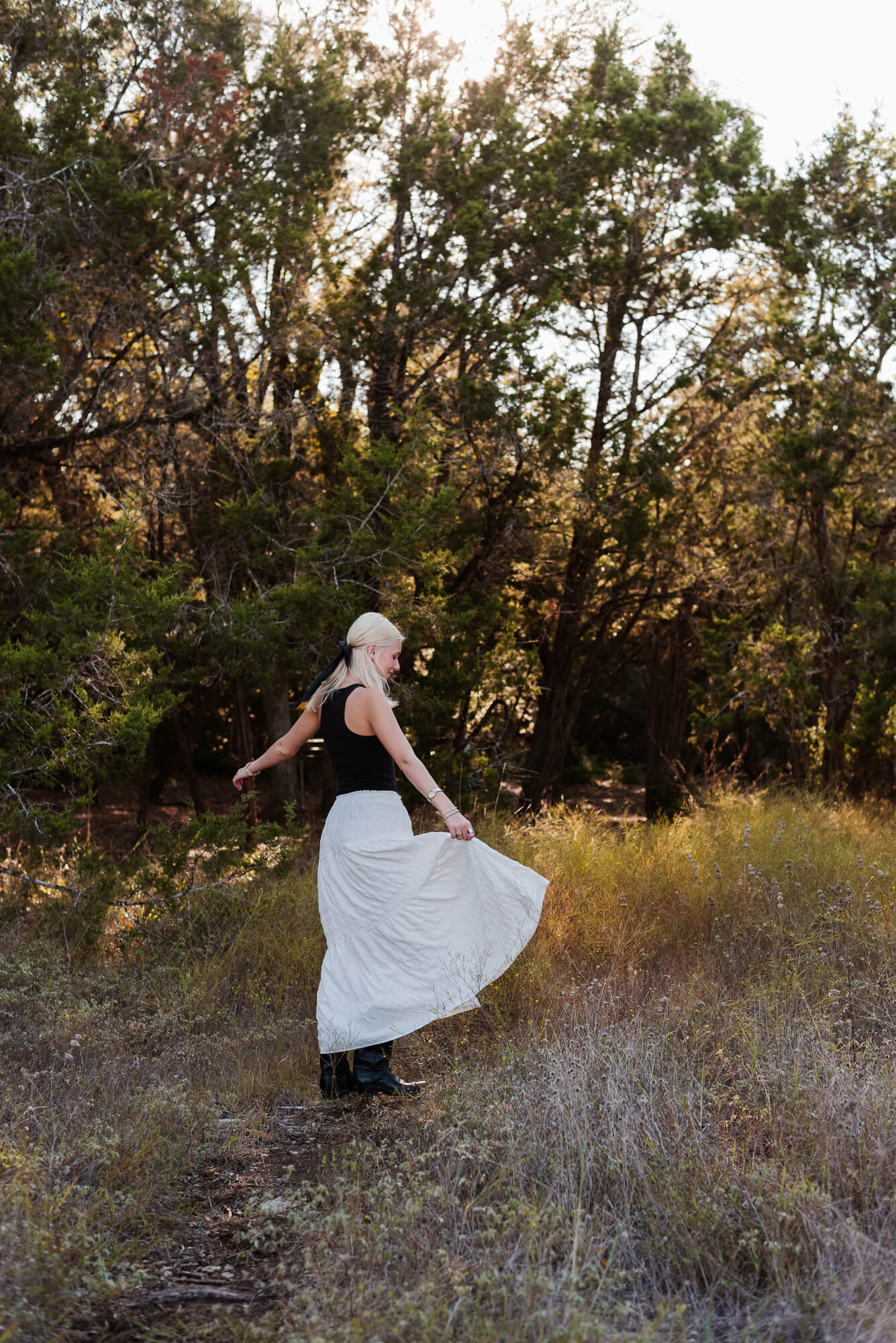 girl dancing and twirling during her senior portraits in austin texas