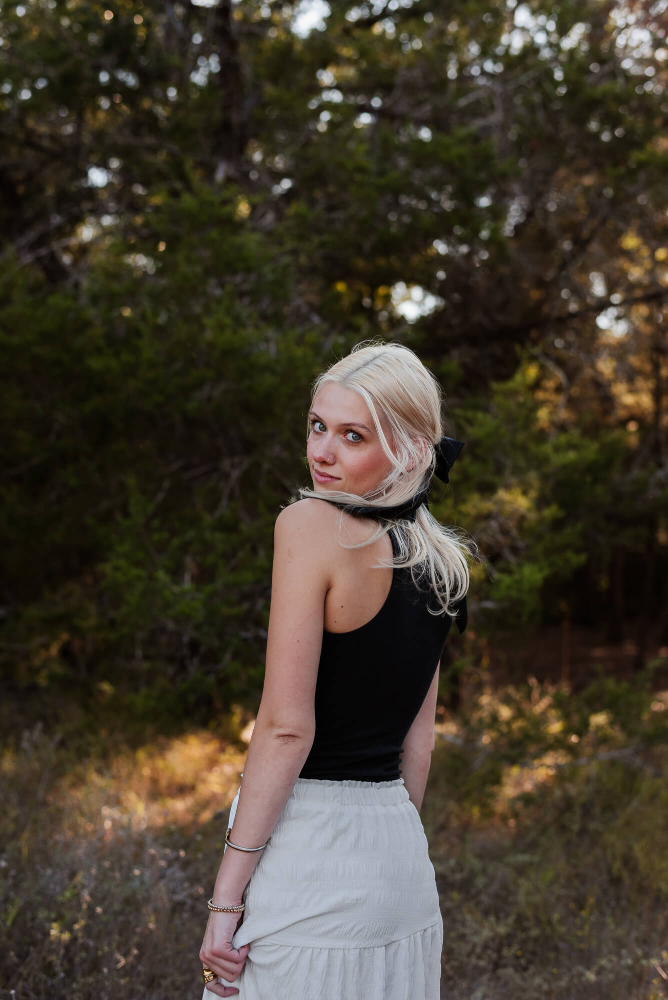 blonde haired senior girl looking at camera seriously during her senior photoshoot