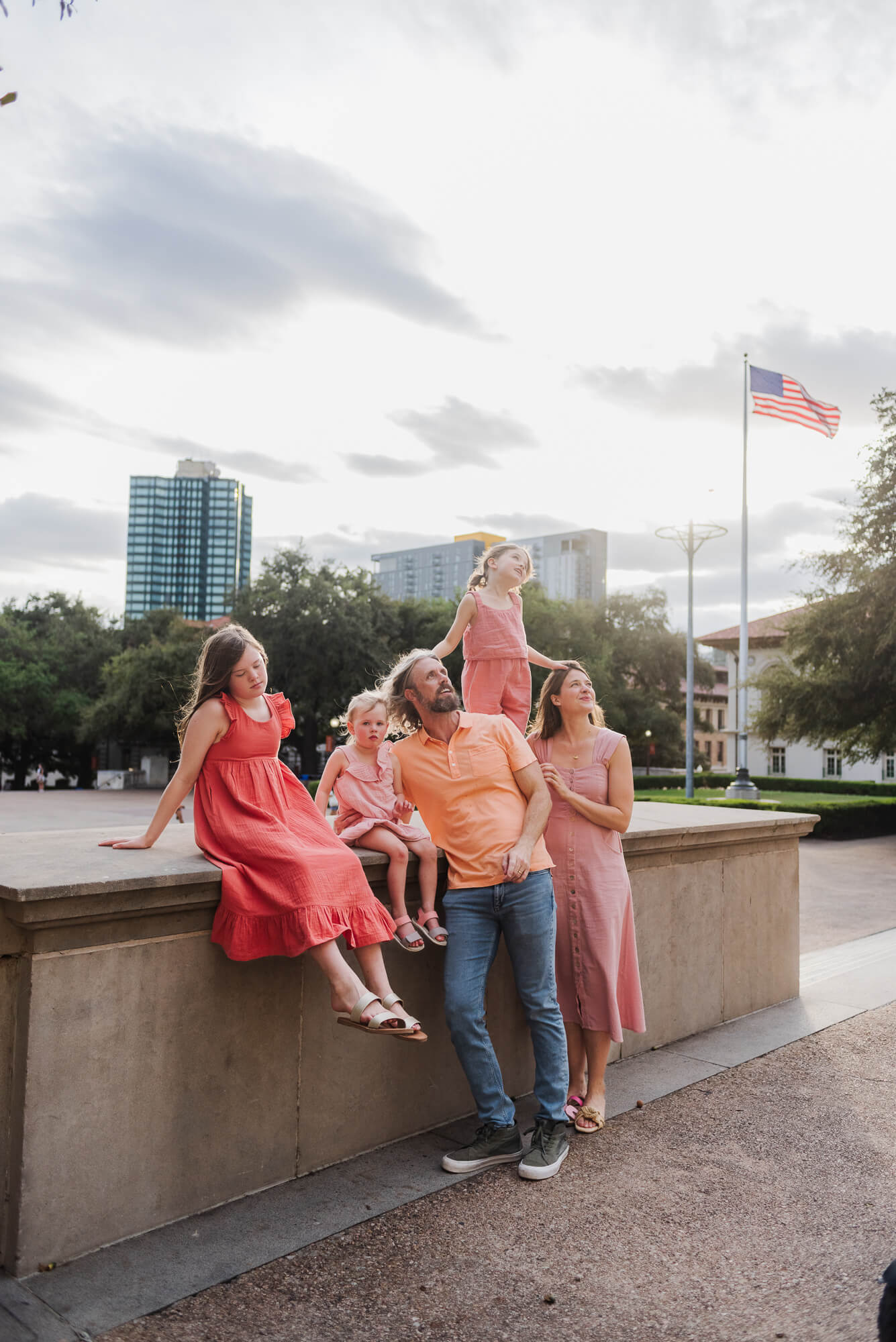 family admiring the tower at the university of texas during a documentary family photoshoot