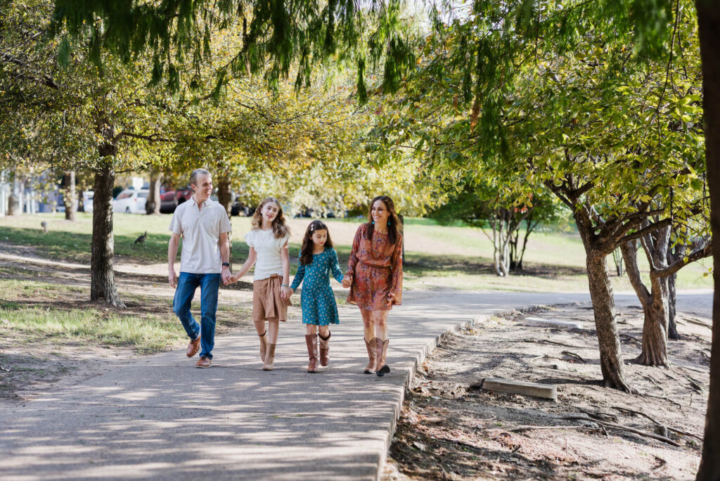 late morning family portrait session with family walking at mueller lake park