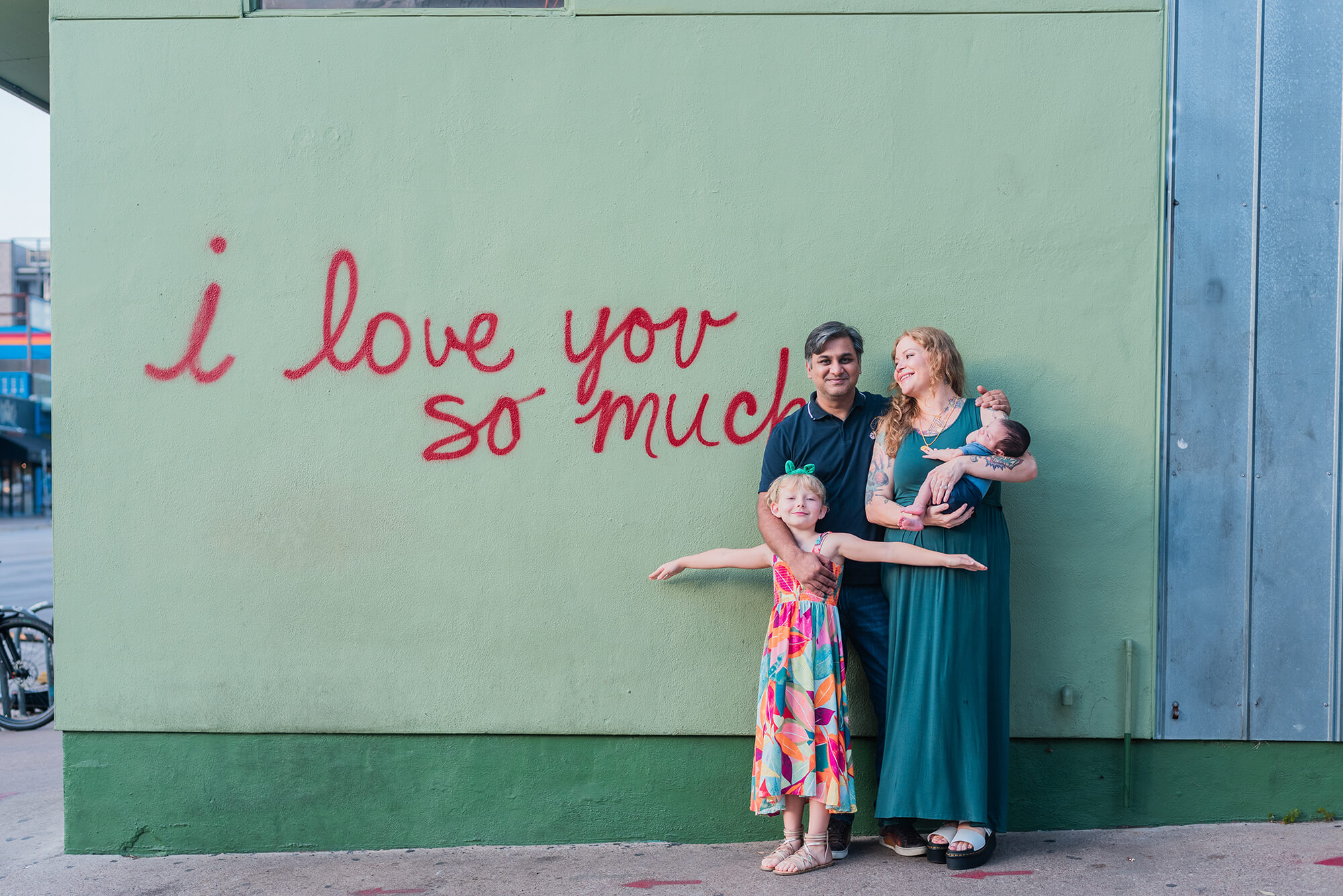 family posing together at famous austin i love you so much mural on south congress ave