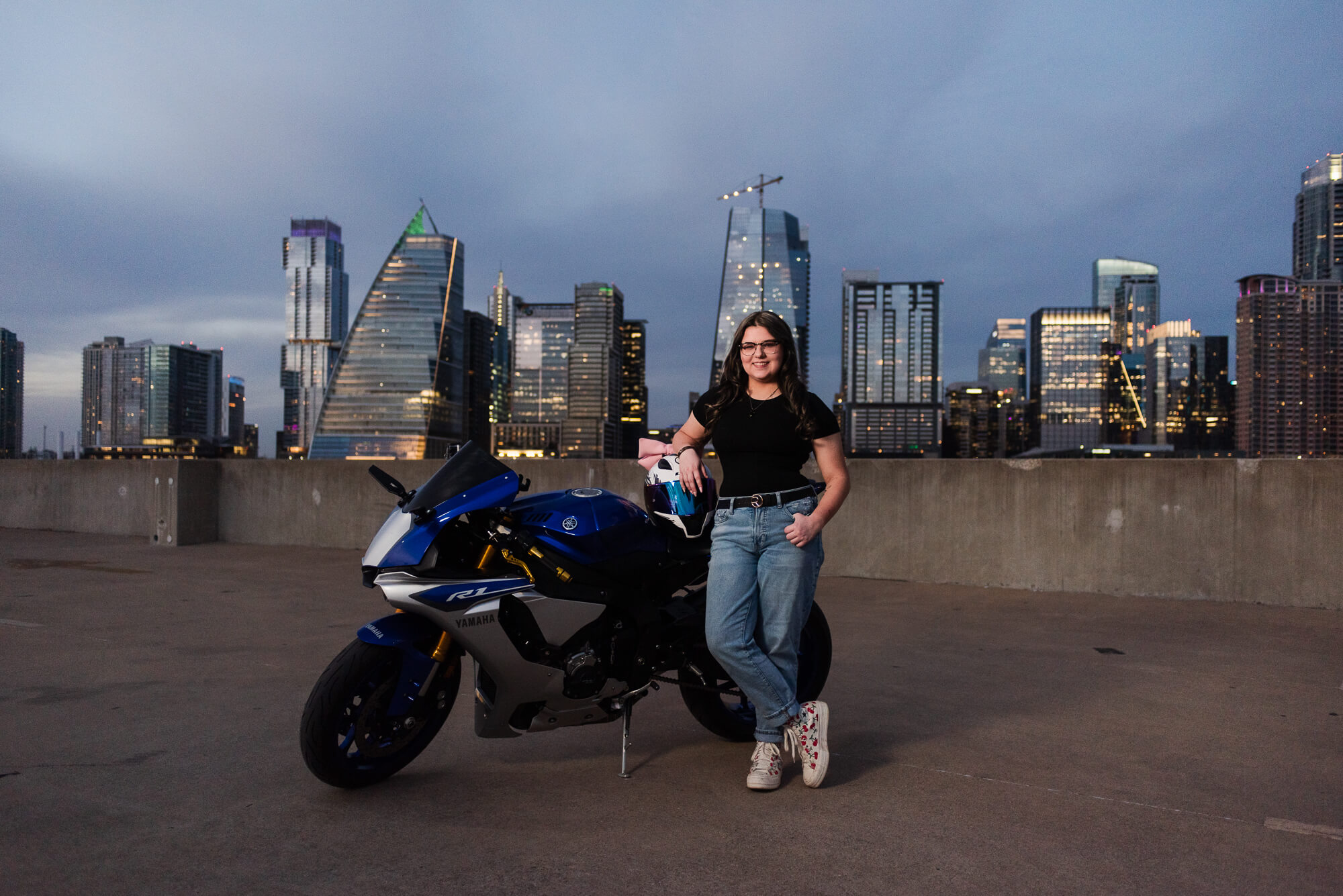 girl with motorcycle on austin rooftop for senior photos