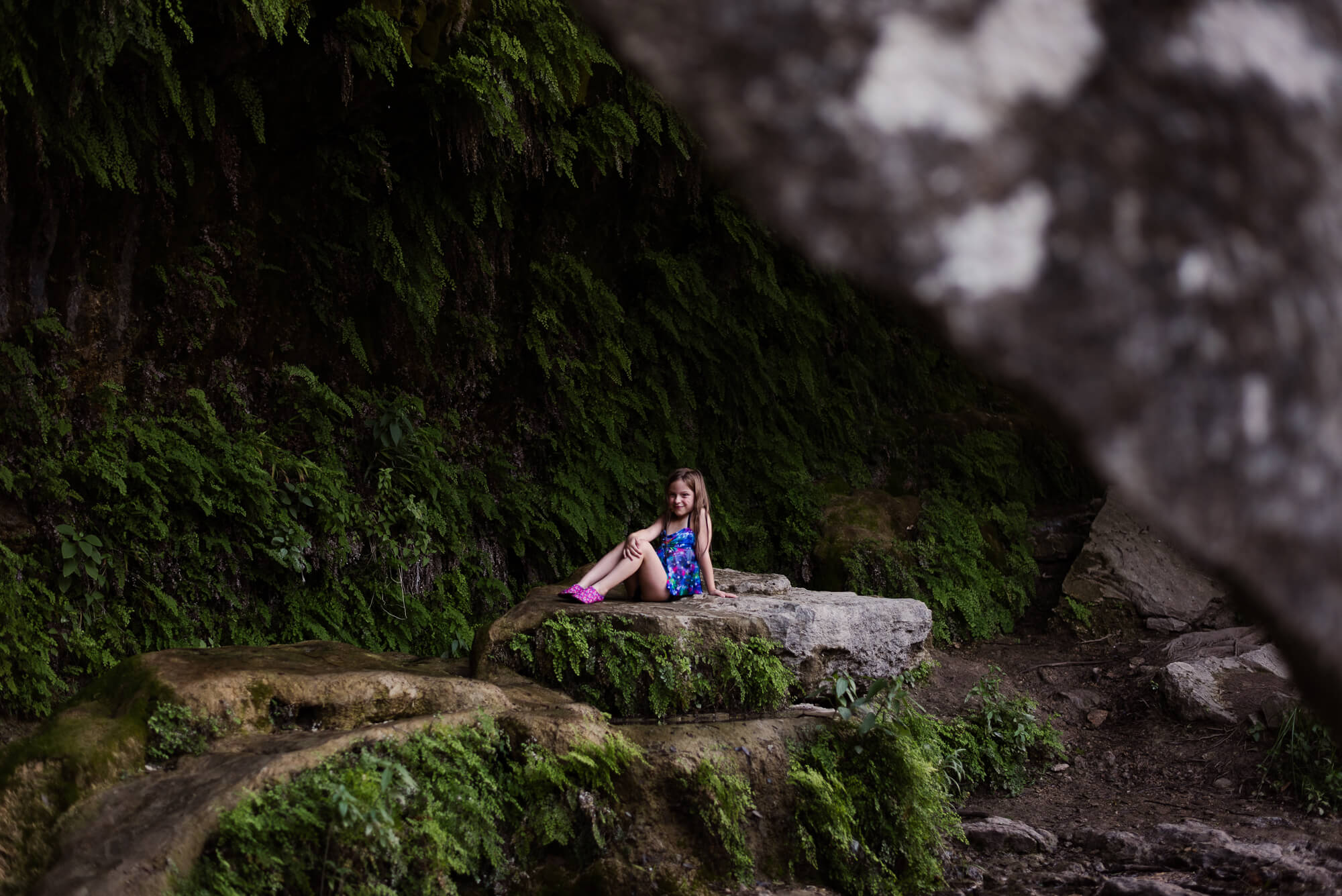 girl sitting on rock at bull creek district park creek