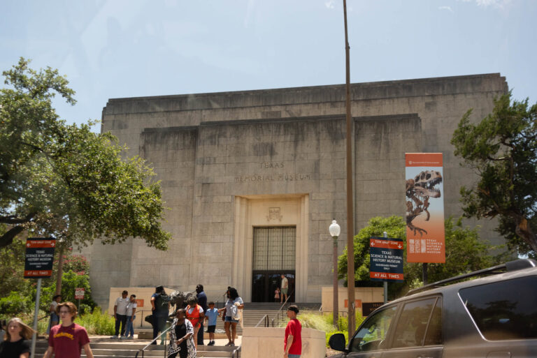 outside view of the texas science and history museum in austin texas as people walk inside