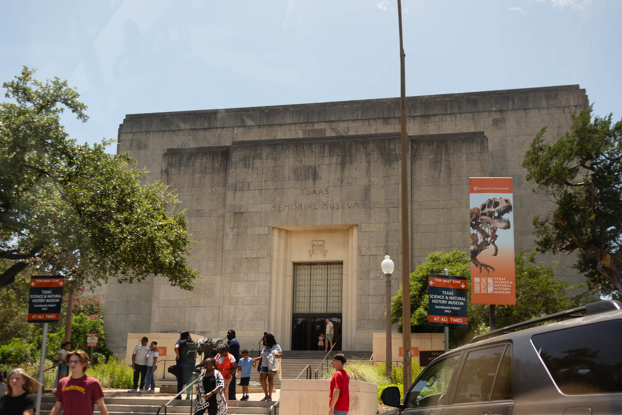 outside view of the texas science and history museum in austin texas as people walk inside