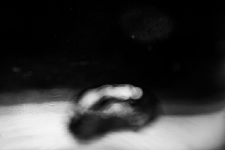 black and white abstract image of water bubbling in a glass kettle on the stove