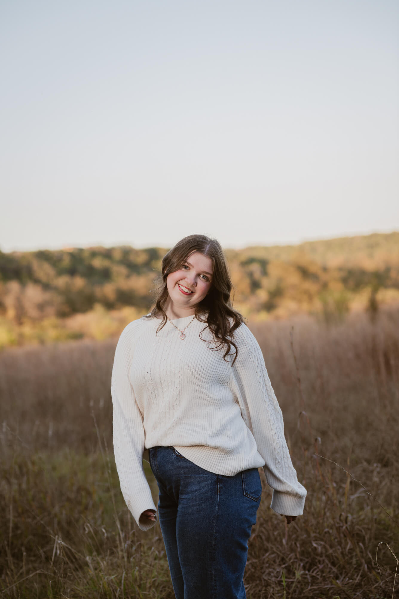 girl with cream sweater during fall senior pictures at commons ford ranch