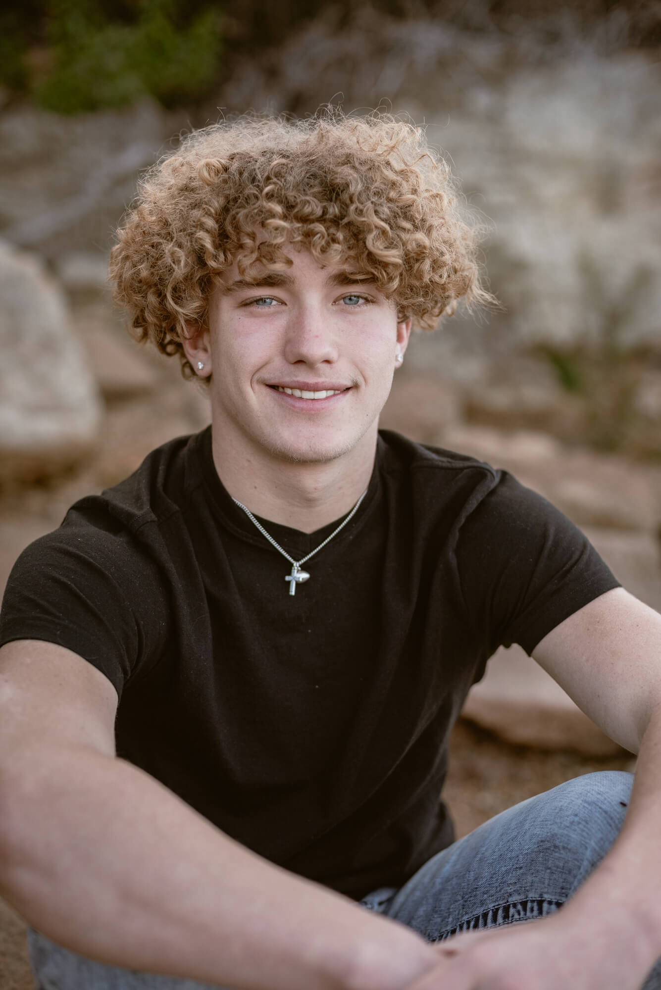 close up senior photo of high school boy with black shirt outside