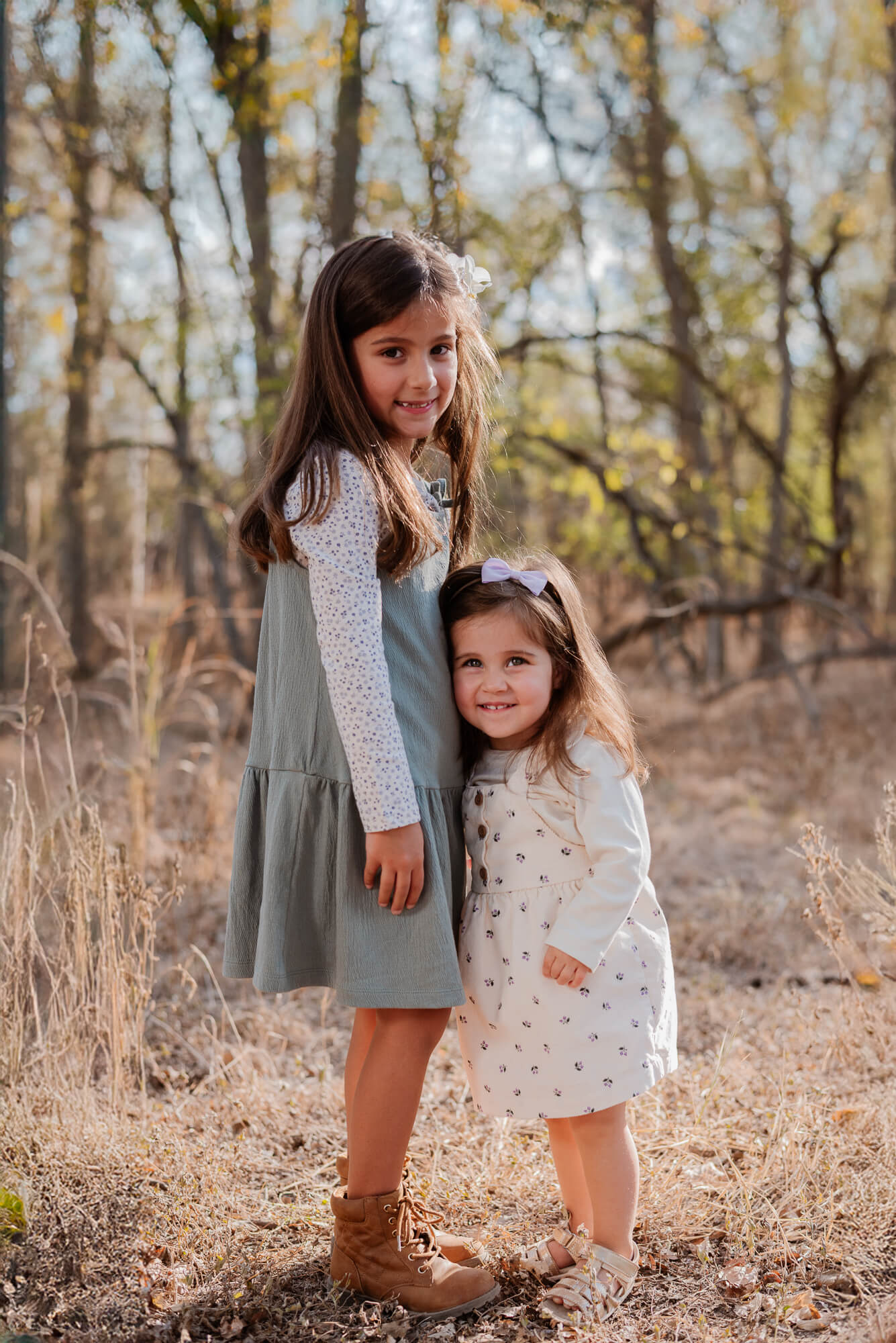 Sisters laughing together during an outdoor family mini session
