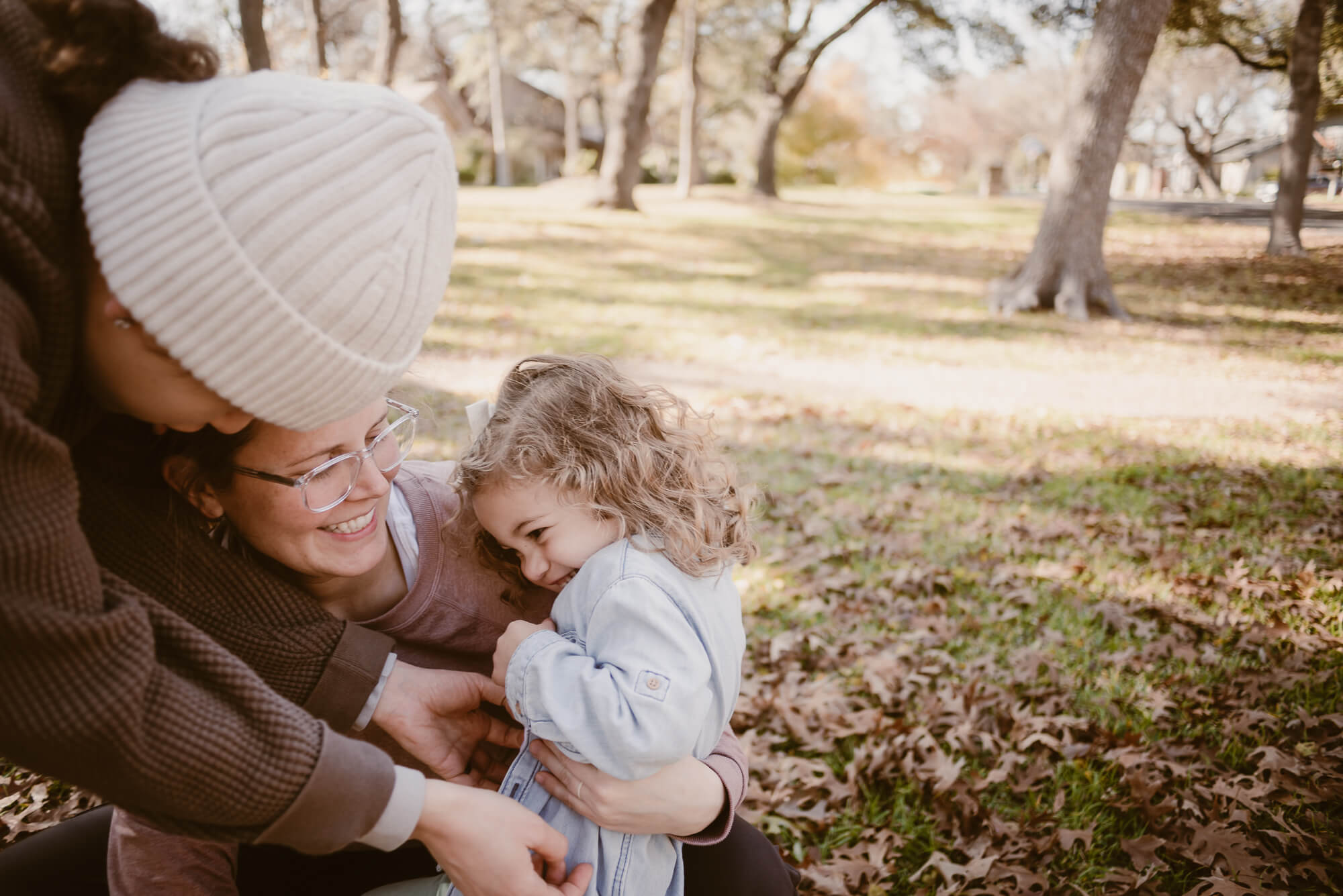 family tickling and playing together at home during an at home family photoshoot