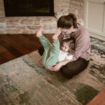 parent playing with their toddler during their indoor family photoshoot