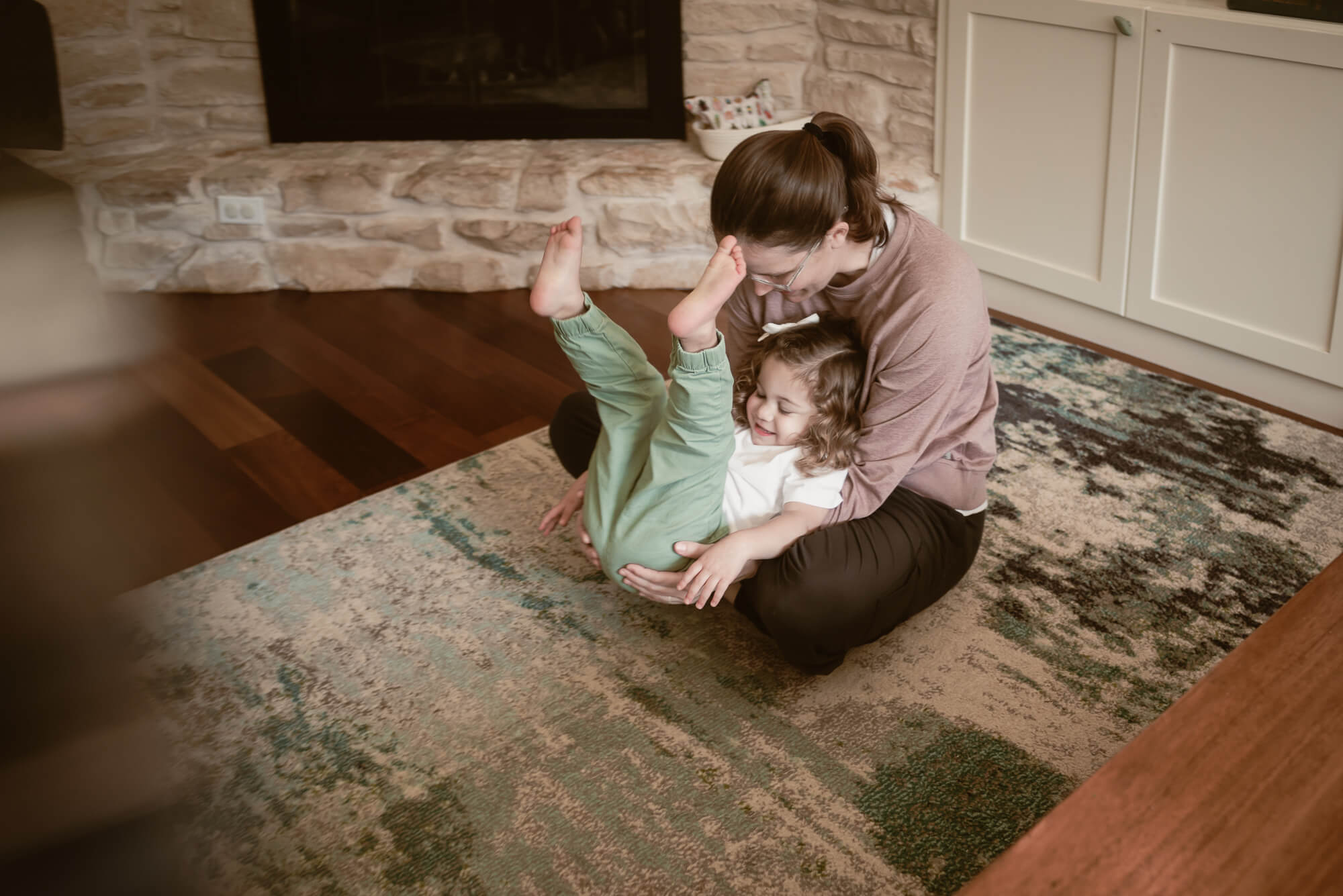 parent playing with their toddler during their indoor family photoshoot