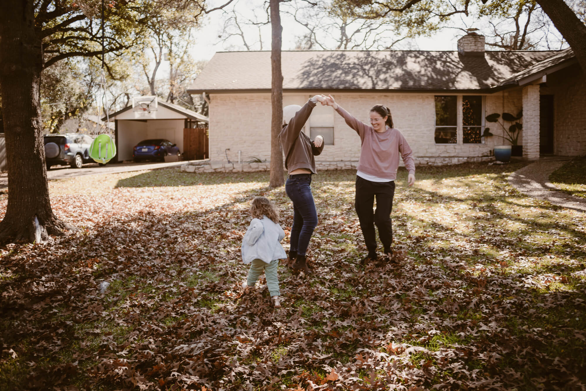 family dancing and playing together at home during an at home family photoshoot